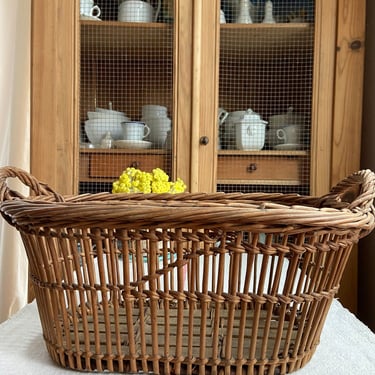 Beautiful vintage French farmhouse picking basket with wooden slats on the base. 