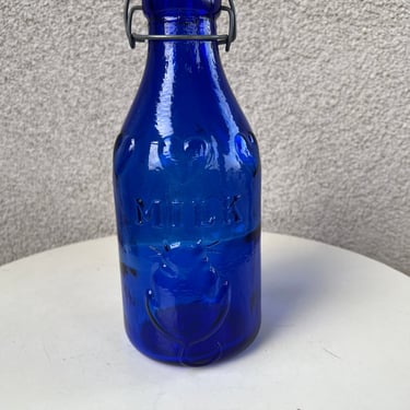Vintage cobalt blue glass 3D Absolutely Pure Milk bottle with wire plastic snap cap 40 oz. Size 10.5” 