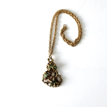 vintage gold tone brutalist style necklace with inlaid stones 