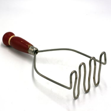 vintage potato masher with red wood handle 