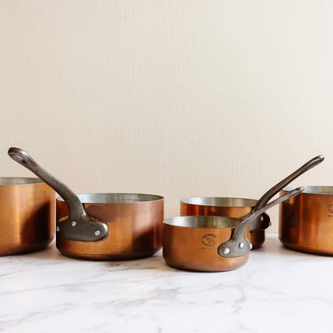 set of five vintage French graduated copper saucepans, stamped “Les Cuivres de Faucogney”