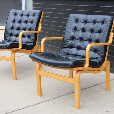 Pair of Scandinavian black leather lounge chairs by Nielaus Møbler 