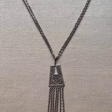 Silver tone tassel and filigree pendant necklace 