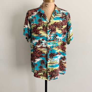 Watumull’s and Leilani 1950s rayon Hawaiian iconic scenes vivid print shirt. Size XL/L 