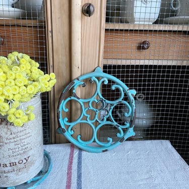 Beautiful rustic old French cast iron trivet in blue turquoise 