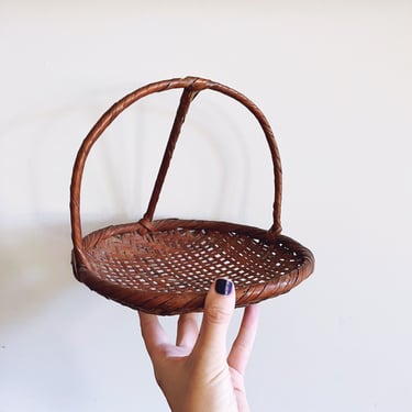 Vintage Handwoven Basket with Unique Handle 