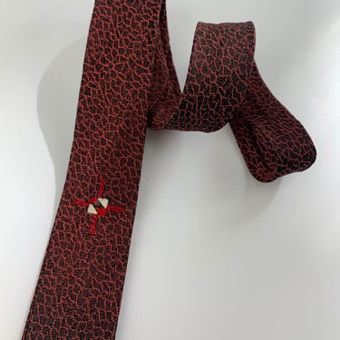 1960's MOD TIE -  Rayon and Acetate - Narrow Width - Peppled Red & Black Background -  Small Crest Detail 