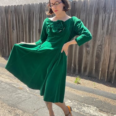 60s emerald green velvet fit and flare dress with large flower at the bust 