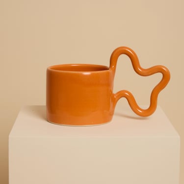 Orange handmade ceramic mug with wiggle handle 