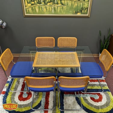 Vintage glass-top dining table in the style of Marcel Breuer