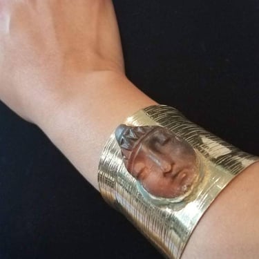 Gold tone wide cuff bracelet with peaceful ceramic face designed by Amanda Alarcon-Hunter for Minx and Onyx Vintage 