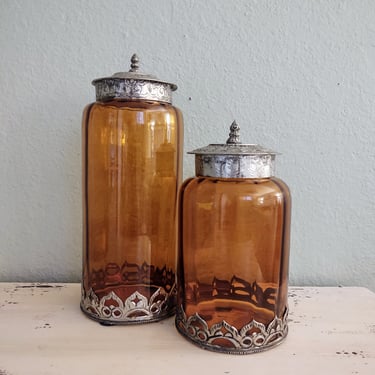 Vintage Orange Glass Containers with Tin Lids and Ornate Bottom Detail 