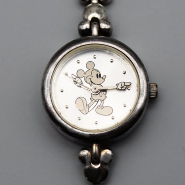 Rare vintage Disney Time Works silver rotating hands Mickey Mouse wrist watch silver tone Mickey heads band 