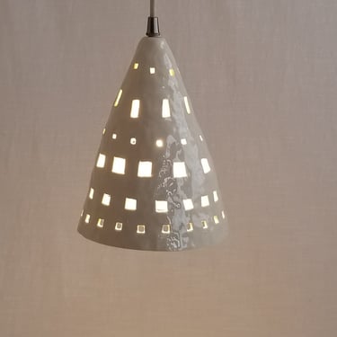 Small ceramic pendant light with one-of-a-kind cutouts 