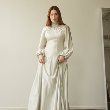 1970s Bright Silver Bishop Sleeve High Collar Gown 