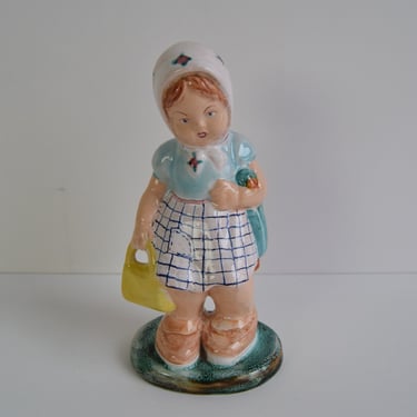 Art Deco Ceramic figurine of a girl with a handbag, circa 1940 