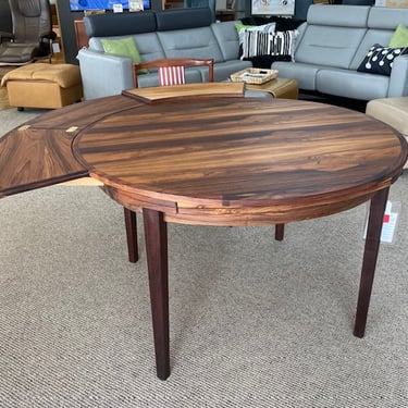 Lotus Table<br />Rosewood Veneer<br />Diameter 47″-68.5″<br />Extensions 11.75″<br />Dyrlund<br />Made in Denmark
