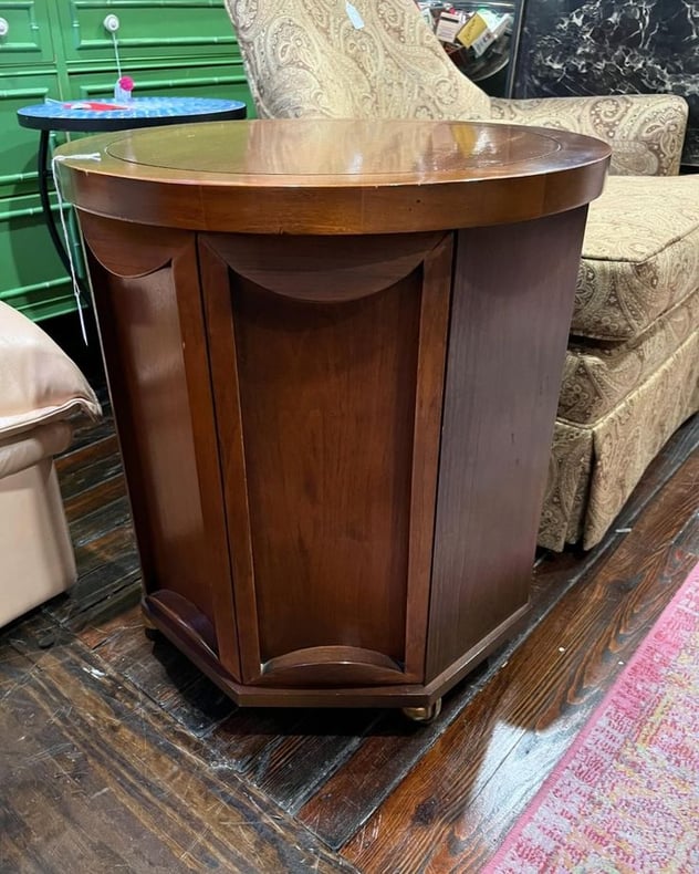 Round walnut side table with a secret door and wheels! 19” across 21” tall 