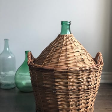vintage demijohn in wicker basket