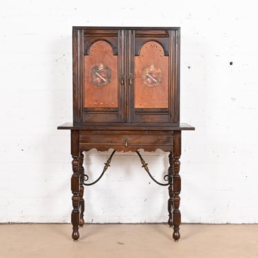 Baker Furniture Spanish Colonial Carved Oak Leather Front Bookcase or Bar Cabinet, Circa 1900