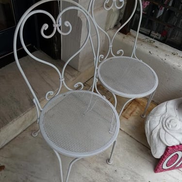 White wrought iron patio chairs. 2 available. 18” x 18” x 38” seat height 17” 