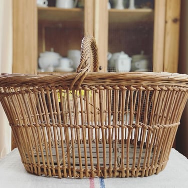Beautiful vintage French farmhouse basket with wooden slats on the base 