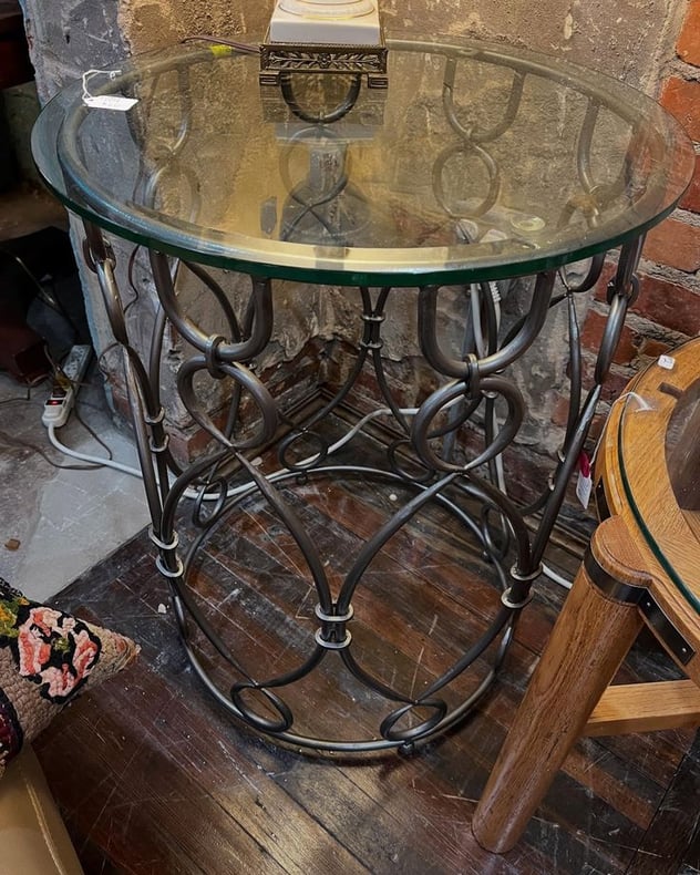 Round metal glass topped side table. 22” across 29” tall 