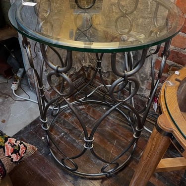 Round metal glass topped side table. 22” across 29” tall 