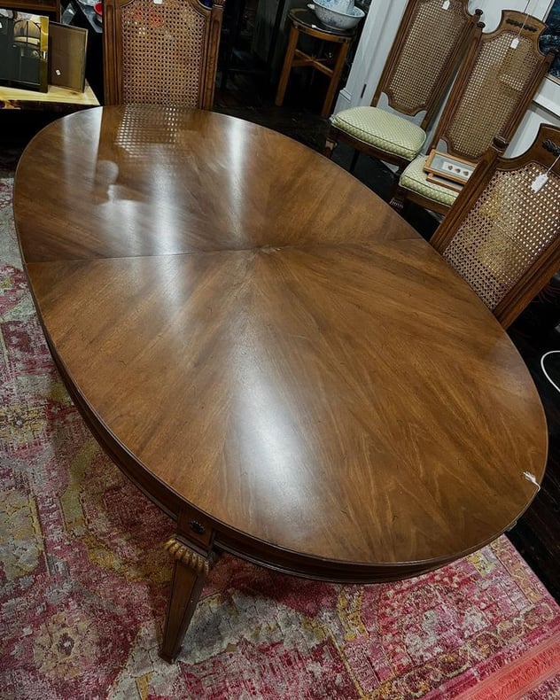 Thomasville fruitwood dining table with two leaves. As shown the table measures 68” x 42.5” x 29.5” The leaves, not shown, measure 18” each. 