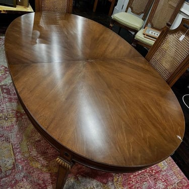 Thomasville fruitwood dining table with two leaves. As shown the table measures 68” x 42.5” x 29.5” The leaves, not shown, measure 18” each. 