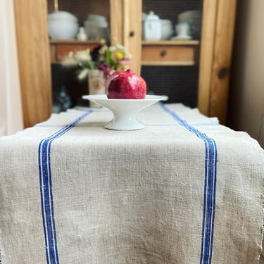 Beautiful vintage French hemp table runner with blue plaid on oat milk background 