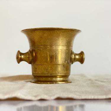 Antique heavy brass mortar. Vintage druggist vessel and kitchen tool for crushing herbs and spices. Rustic kitchen decor. 