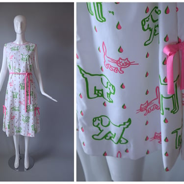 Vintage 1960s The Vested Gentress White and Pink Large Print 'Raining Cats and Dogs' Sleeveless Belted Shift Dress | old school 190s | size 