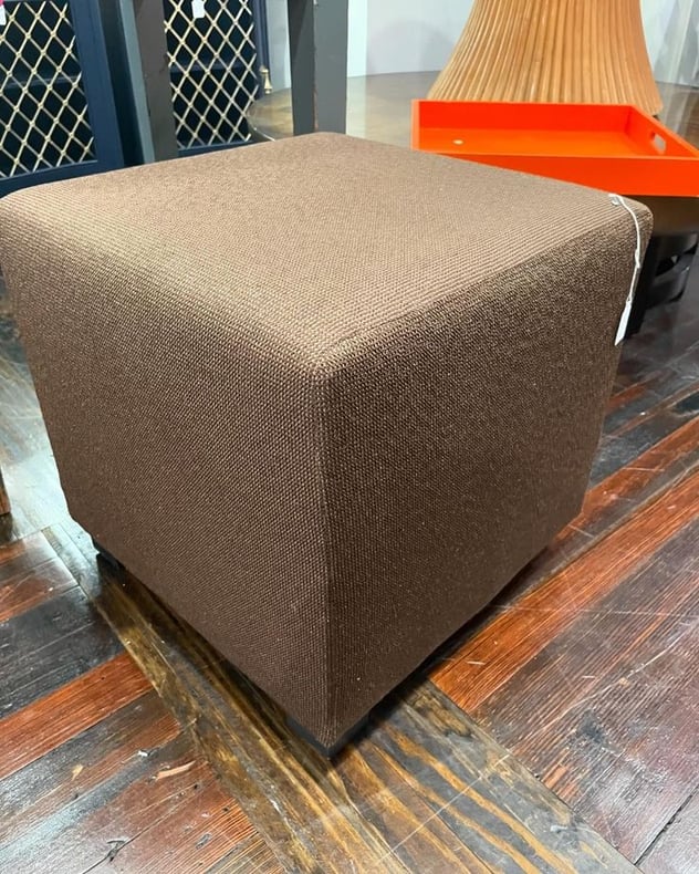 A perfectly square and brown ottoman 18x18x18” 