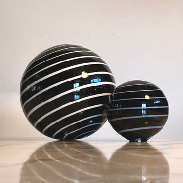 Set of two handmade striped globe table decorations in striped black and white glass 