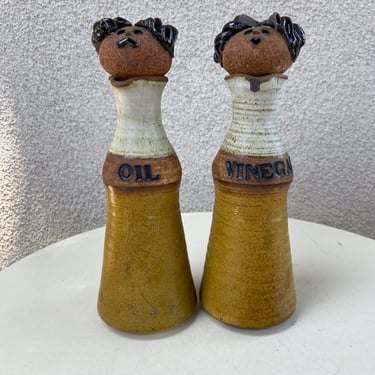 Vintage wounded bird kitsch stoneware oil vinegar bottles with man women stoppers by CK pottery 