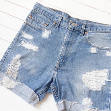 high waisted jean shorts | 90s vintage Levi's 517 distressed thrashed frayed soft faded cut off denim shorts 