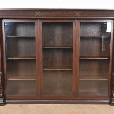 R. J. Horner Style American Empire Carved Oak Glass Front Triple Bookcase, Circa 1900