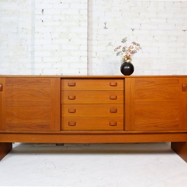 Vintage MCM Danish teak credenza w sliding doors and 4 drawers by Domino Furniture | Free delivery in NYC and Hudson Valley areas 