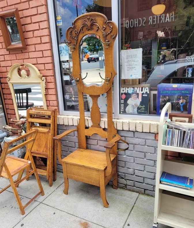 Early 20th Century Oak Hall Tree. Flip up seat for storage, clear beveled mirror, four brass hat/coat hooks, umbrella holder.…