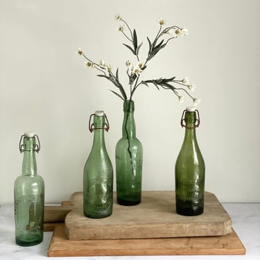 set of four vintage French brasserie bottles