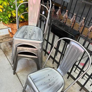 Gray metal chairs. Stackable too! 8 available. 15” x14.5” x 32.5” seat height 17.5” 