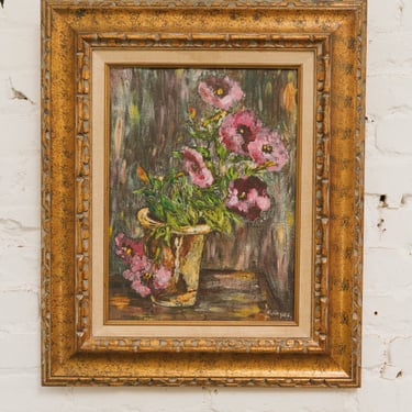 Painting of flowers in a vase, framed in an ornate gold frame