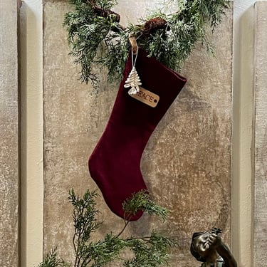 Traditional Christmas burgundy red stocking handmade in wool, embellished with a hand stamped leather label and matching leather hanging tag 
