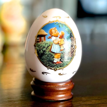 VINTAGE: 1994 - Hummel Pale Pink Porcelain Egg with Wood Stand - "Kiss Me" - The M. J. Hummel Porcelain Egg Collection - SKU 15-F1-00013760 