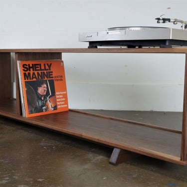 Mid-century modern stereo console for a record player and record storage. The 