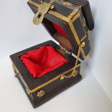 Wood and brass grommet box with red lining 