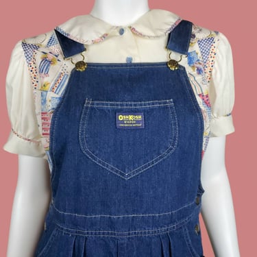 Denim overall dress by Osh Kosh B'gosh. Vintage 70s cottage core hippie iconic traditional timeless. Mid length. Vest back. (30 waist) 