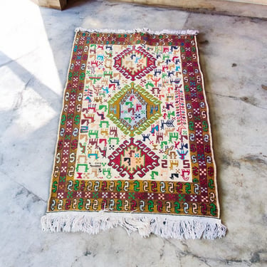 Beautiful Wool Rug with Colorful Animals on it