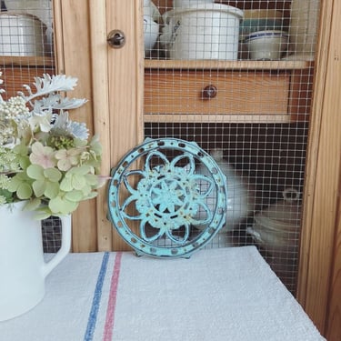Beautiful vintage French cast iron trivet in blue 